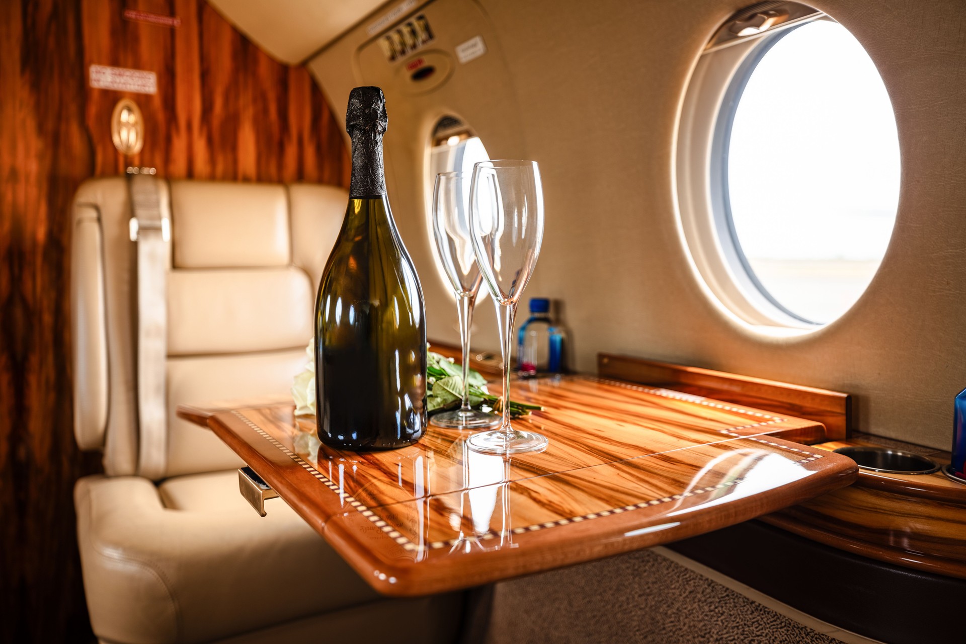 Champagne and Flowers on Table on Private Jet